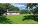 Rear of home with an outdoor deck and a large grassy yard, perfect for outdoor activities at 4395 Burton Rd, Maiden, NC 28650