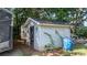 Utility shed and trash receptacle are tucked away under mature trees at 4395 Burton Rd, Maiden, NC 28650