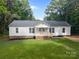 Charming one-story home featuring a classic white exterior, a welcoming front porch, and a well-manicured front lawn at 442 Lovelace Rd, Rock Hill, SC 29730
