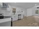 Modern kitchen featuring stainless steel appliances, sleek countertops, and bright white cabinetry with wood-look flooring at 442 Lovelace Rd, Rock Hill, SC 29730