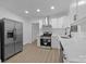 Stylish kitchen featuring stainless steel appliances, bright white cabinetry, modern fixtures and ample counter space at 442 Lovelace Rd, Rock Hill, SC 29730