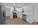Bright kitchen with stainless steel appliances, white cabinetry, solid surface counters and modern fixtures at 442 Lovelace Rd, Rock Hill, SC 29730