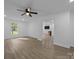 Spacious living room with wood-look floors, neutral walls, a large window, and a modern ceiling fan at 442 Lovelace Rd, Rock Hill, SC 29730
