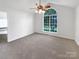 Unfurnished bedroom with a large window, ceiling fan, and neutral carpet flooring at 4550 Briarcreek Rd, Maiden, NC 28650