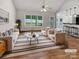 Bright living room with hardwood floors, neutral decor, and views of the landscaped backyard at 4550 Briarcreek Rd, Maiden, NC 28650