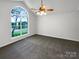 Empty main bedroom featuring a large window, ceiling fan, and neutral carpet flooring at 4550 Briarcreek Rd, Maiden, NC 28650