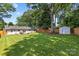 Large backyard with lush green lawn, storage shed and patio at 5329 Valley Forge Rd, Charlotte, NC 28210