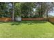 Expansive backyard features lush green lawn, storage shed and privacy fence at 5329 Valley Forge Rd, Charlotte, NC 28210