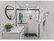 Bathroom with a shower, white vanity with faucet, round mirror, and a hanging succulent at 5329 Valley Forge Rd, Charlotte, NC 28210