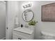Bathroom featuring white vanity, round mirror, and a vessel sink at 5329 Valley Forge Rd, Charlotte, NC 28210