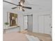 Spacious bedroom with a ceiling fan, artwork, closets, and a gray barn door at 5329 Valley Forge Rd, Charlotte, NC 28210