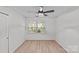 Bright bedroom with a ceiling fan and natural light from the window. The floors are hardwood at 5329 Valley Forge Rd, Charlotte, NC 28210