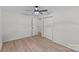 Neutral bedroom with a ceiling fan, hardwood floors and double closets at 5329 Valley Forge Rd, Charlotte, NC 28210