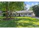 Charming single-story home featuring mature trees, a lush green lawn, and classic curb appeal at 5329 Valley Forge Rd, Charlotte, NC 28210