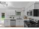Modern kitchen with stainless steel appliances, white cabinets, and stylish countertops at 5329 Valley Forge Rd, Charlotte, NC 28210