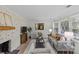Warm and inviting living room with a brick fireplace, modern decor, and ample natural light at 5329 Valley Forge Rd, Charlotte, NC 28210