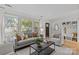Bright living room featuring a large window, comfortable seating, and modern decor at 5329 Valley Forge Rd, Charlotte, NC 28210
