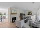 Cozy living room featuring a painted brick fireplace, stylish furnishings, and hardwood flooring at 5329 Valley Forge Rd, Charlotte, NC 28210