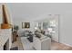Bright living room with a decorative fireplace, comfortable seating, and large windows at 5329 Valley Forge Rd, Charlotte, NC 28210