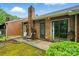 Cozy backyard featuring a brick chimney, small patio with seating, and sliding glass door for easy indoor-outdoor flow at 656 Ne Camrose Ne Cir, Concord, NC 28025