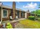 Brick patio area with a sliding glass door, perfect for outdoor relaxation in this private backyard retreat at 656 Ne Camrose Ne Cir, Concord, NC 28025