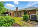 Charming backyard with brick accents, small patio, and lush landscaping providing a serene outdoor space at 656 Ne Camrose Ne Cir, Concord, NC 28025