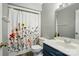 Bathroom featuring a floral shower curtain and a new sink and cabinet at 656 Ne Camrose Ne Cir, Concord, NC 28025