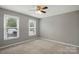 Bedroom features two windows allowing natural light and neutral colored walls at 656 Ne Camrose Ne Cir, Concord, NC 28025