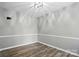 Neutral bedroom with wood-look floors, crown molding, and overhead lighting at 656 Ne Camrose Ne Cir, Concord, NC 28025