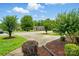 Street view of a home with mature trees, shrubs, and a wide driveway at 656 Ne Camrose Ne Cir, Concord, NC 28025