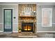 Living room features a stone fireplace with wooden mantel and stylish decor at 656 Ne Camrose Ne Cir, Concord, NC 28025