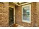 Close-up of a brick home's front entrance with a glass door at 656 Ne Camrose Ne Cir, Concord, NC 28025