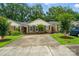 Well-maintained brick townhomes with a spacious driveway and landscaped front yards, showcasing curb appeal at 656 Ne Camrose Ne Cir, Concord, NC 28025