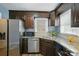 Updated kitchen features stainless steel appliances, granite counters, and dark wood cabinets at 656 Ne Camrose Ne Cir, Concord, NC 28025