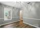Bright living room with wood-look floors, crown molding and a window view at 656 Ne Camrose Ne Cir, Concord, NC 28025
