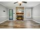 Bright living room featuring stone fireplace and ceiling fan at 656 Ne Camrose Ne Cir, Concord, NC 28025