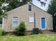 Rear view of the property highlighting the siding, a bright blue back door, and a compact AC unit at 659 Annafrel St, Rock Hill, SC 29730