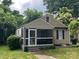 Inviting exterior showcasing a screened porch, well-maintained siding, and lush greenery surrounding the property at 659 Annafrel St, Rock Hill, SC 29730