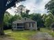 Cozy home with a screened front porch, neutral siding, a small garden, and a gated driveway at 659 Annafrel St, Rock Hill, SC 29730