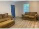 Cozy living room with new flooring, comfortable seating, and a bright blue door for a pop of color at 659 Annafrel St, Rock Hill, SC 29730