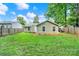 Backyard featuring privacy fence, green lawn, and exterior view of the home at 6705 Reddman Rd, Charlotte, NC 28212