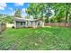Backyard featuring privacy fence, green lawn, and exterior view of the home at 6705 Reddman Rd, Charlotte, NC 28212