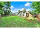 Backyard showcasing well maintained lawn, mature trees, a privacy fence and exterior of the home at 6705 Reddman Rd, Charlotte, NC 28212
