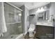 Well lit bathroom featuring a glass enclosed shower and modern vanity at 6705 Reddman Rd, Charlotte, NC 28212