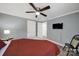 Bedroom features a ceiling fan, TV, and soothing wall color at 6705 Reddman Rd, Charlotte, NC 28212