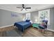 Cozy bedroom featuring a ceiling fan, windows, and a nightstand at 6705 Reddman Rd, Charlotte, NC 28212