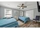 Cozy bedroom with two twin beds, a ceiling fan and a window at 6705 Reddman Rd, Charlotte, NC 28212