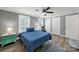 Inviting bedroom featuring a ceiling fan, nightstand, and natural light from windows at 6705 Reddman Rd, Charlotte, NC 28212