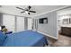 Comfortable bedroom featuring ceiling fan, connecting bath, and view of entry door at 6705 Reddman Rd, Charlotte, NC 28212