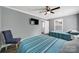 Light-filled bedroom with two twin beds, ceiling fan, window, and a view of the doorway at 6705 Reddman Rd, Charlotte, NC 28212